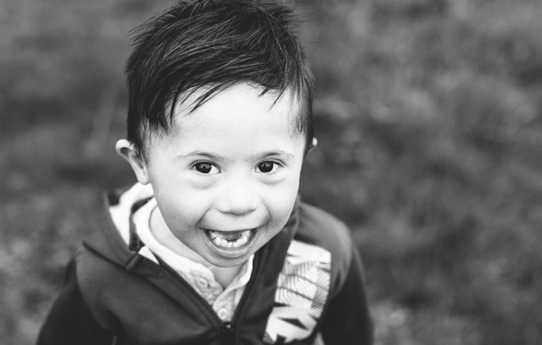 A smiling young boy with Down syndrome